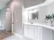 Bright bathroom features a modern vanity with sleek fixtures and marble countertops at 5809 Silas Creek Ln, Wesley Chapel, FL 33545
