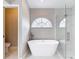 Luxurious bathroom featuring a standalone tub, walk-in shower, and stylish finishes at 5809 Silas Creek Ln, Wesley Chapel, FL 33545