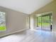 Bright, open bedroom features neutral walls, large windows, and access to the lanai at 5809 Silas Creek Ln, Wesley Chapel, FL 33545
