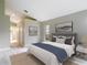 Comfortable bedroom features a large bed, neutral decor, and plenty of natural light at 5809 Silas Creek Ln, Wesley Chapel, FL 33545