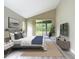 Bright bedroom features a bed, neutral decor, and access to the lanai at 5809 Silas Creek Ln, Wesley Chapel, FL 33545