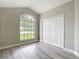 Bright bedroom features a large window, neutral decor, and a spacious closet at 5809 Silas Creek Ln, Wesley Chapel, FL 33545