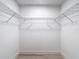 Walk-in closet with white wire shelving and ample storage space at 5809 Silas Creek Ln, Wesley Chapel, FL 33545