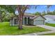 Charming home with a lush lawn, a neutral color scheme, and a well-manicured garden at 5809 Silas Creek Ln, Wesley Chapel, FL 33545