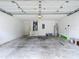 Two car garage with room for storage, an access door, and painted white walls at 5809 Silas Creek Ln, Wesley Chapel, FL 33545