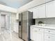 Bright eat-in kitchen boasts stainless steel refrigerator and expansive countertops, perfect for entertaining at 5809 Silas Creek Ln, Wesley Chapel, FL 33545