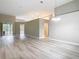 Bright and open living space with a chandelier, neutral walls, and modern gray flooring at 5809 Silas Creek Ln, Wesley Chapel, FL 33545