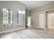 Large windows allow ample light into this space featuring updated floors and modern lighting at 5809 Silas Creek Ln, Wesley Chapel, FL 33545
