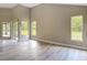 Bright and spacious living area with large windows offering views of the green backyard for comfortable living at 5809 Silas Creek Ln, Wesley Chapel, FL 33545