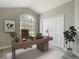Modern office with neutral decor, large window, and a spacious desk at 5809 Silas Creek Ln, Wesley Chapel, FL 33545