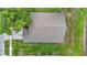 Aerial view of a home's roof with a textured pattern and partial tree shade at 5809 Silas Creek Ln, Wesley Chapel, FL 33545