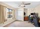 Bedroom featuring tile floor, ceiling fan, natural light, and closet with shelving at 6011 Pratt St, Tampa, FL 33647