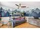 bedroom featuring a mountain mural, playful bunk beds and wood-look floors at 6011 Pratt St, Tampa, FL 33647