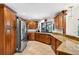 Spacious kitchen featuring custom wood cabinetry, stainless steel appliances, granite countertops, and tile flooring at 6011 Pratt St, Tampa, FL 33647