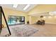 Spacious living room with sliding glass doors to pool, skylights, and adjacent dining area at 6011 Pratt St, Tampa, FL 33647