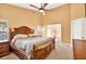 Vaulted ceiling main bedroom showcasing a decorative wood bed frame and plantation shutters at 6011 Pratt St, Tampa, FL 33647