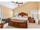 Vaulted ceiling main bedroom showcasing a decorative wood bed frame and plantation shutters at 6011 Pratt St, Tampa, FL 33647