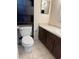 Bathroom with vanity, toilet, and black storage cabinet at 6324 Newtown Cir # 24B2, Tampa, FL 33615