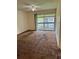 Bedroom with a ceiling fan, carpet, and sliding doors to the outdoor screened in patio at 6324 Newtown Cir # 24B2, Tampa, FL 33615