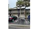 Two-story condo building with covered walkways, reserved parking and tall palm trees at 6324 Newtown Cir # 24B2, Tampa, FL 33615