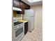 Kitchen with white range, oven, and refrigerator at 6324 Newtown Cir # 24B2, Tampa, FL 33615