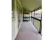 Screened in patio with workspace and sliding door at 6324 Newtown Cir # 24B2, Tampa, FL 33615