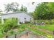 View of backyard garden featuring raised beds and patio seating, blending nature and comfort at 6412 S Richard Ave, Tampa, FL 33616
