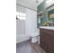Well-lit bathroom featuring a shower/tub combo, vanity with dark cabinets, and modern finishes at 6412 S Richard Ave, Tampa, FL 33616