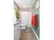 Compact bathroom with a shower/tub combo, vanity, and modern accents for convenience and comfort at 6412 S Richard Ave, Tampa, FL 33616