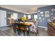 Bright dining room with hardwood floors, modern table and chairs, and decorative sunflowers at 6412 S Richard Ave, Tampa, FL 33616