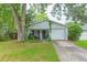 Charming single-story home with attached garage, front porch, and well-maintained lawn at 6412 S Richard Ave, Tampa, FL 33616