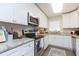 Bright kitchen with white cabinets, granite countertops, and stainless steel appliances at 6412 S Richard Ave, Tampa, FL 33616