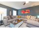 Spacious living room featuring a large sectional sofa, stylish decor, and ample natural light at 6412 S Richard Ave, Tampa, FL 33616