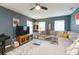 Comfortable living room with a sectional sofa, ceiling fan, and an area rug at 6412 S Richard Ave, Tampa, FL 33616