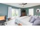 Spacious main bedroom with an ensuite, natural light, and a decorative accent chair at 6412 S Richard Ave, Tampa, FL 33616