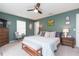 Comfortable main bedroom featuring ample natural light, a ceiling fan, and stylish decor at 6412 S Richard Ave, Tampa, FL 33616