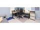 Bright home office featuring a height-adjustable desk, ergonomic chair, and natural light at 6412 S Richard Ave, Tampa, FL 33616