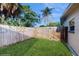 A wood fence with gate surrounds the manicured backyard lawn at 6901 10Th N St, St Petersburg, FL 33702