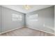 Simple bedroom with carpet flooring, neutral walls, and natural light from two windows at 6901 10Th N St, St Petersburg, FL 33702