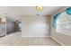Bright dining room features wood-look tile floors and a large window with natural light at 6901 10Th N St, St Petersburg, FL 33702