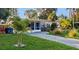 Charming single-story home featuring a well-manicured lawn and a paved driveway at 6901 10Th N St, St Petersburg, FL 33702