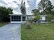 Charming single-story home featuring a spacious screen enclosed garage and well-maintained lawn at 6901 10Th N St, St Petersburg, FL 33702