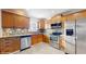 Stylish kitchen with stainless steel appliances, tile backsplash, and wood cabinets at 6901 10Th N St, St Petersburg, FL 33702