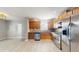 Spacious kitchen with stainless steel appliances, wood cabinets, and tiled backsplash at 6901 10Th N St, St Petersburg, FL 33702