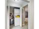 A laundry closet features a stacked washer and dryer plus a water heater at 6901 10Th N St, St Petersburg, FL 33702