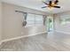 Open living room with plank flooring and a ceiling fan at 6901 10Th N St, St Petersburg, FL 33702