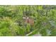 Aerial view of the home nestled within mature trees at 6901 Arbor Oaks Ct, Bradenton, FL 34209