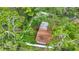 Aerial view of the home showing mature trees and a fenced yard at 6901 Arbor Oaks Ct, Bradenton, FL 34209