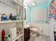 Bathroom features include light blue walls, wood-look floors, and white wainscoting at 6901 Arbor Oaks Ct, Bradenton, FL 34209