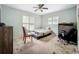 Bedroom featuring two windows for natural light, light blue walls, and a ceiling fan at 6901 Arbor Oaks Ct, Bradenton, FL 34209